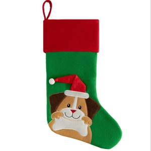 Green Christmas stocking with a cute cartoon dog in a red hat on white background