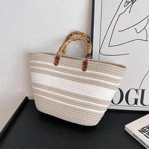 Chic woven tote bag with bamboo handles and beige striped pattern for summer
