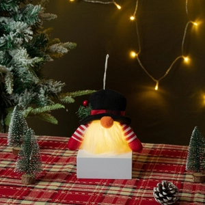 Luminous Christmas gnome with LED glowing beard and black plaid hat on festive backdrop