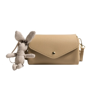 Minimalist khaki square crossbody bag with gold buckle and cute rabbit plush charm