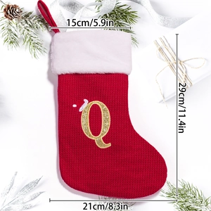 Detail view of red knitted Christmas stocking with gold letter Q and size dimensions