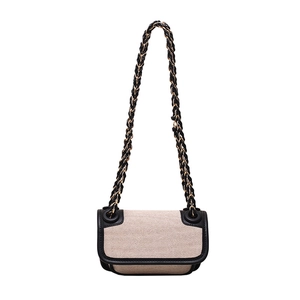 Beige woven tweed crossbody bag with black leather trim and elegant gold chain strap
