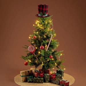 Close-up of red and black buffalo plaid Christmas tree topper hat with pine and berry details