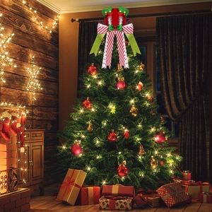 Close-up of festive elf-themed Christmas tree topper with red and green bow decorations