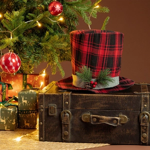 Detail of red and black buffalo plaid Christmas top hat tree topper on a vintage suitcase