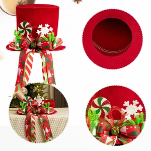 Red velvet Christmas tree topper hat with festive lollipop decor and snowflake ribbons