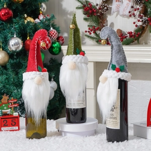 Close-up of three festive gnome wine bottle covers with faux fur beards and bells