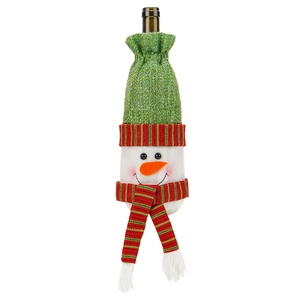 Detail of Christmas snowman wine bottle cover with green knit hat and striped scarf