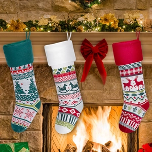 Close-up of knit Christmas stockings set with festive patterns on a cozy fireplace