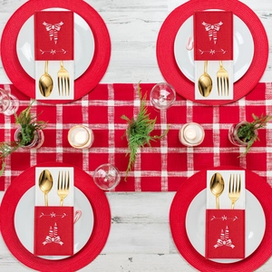 Set of 4 red felt Christmas cutlery holders with festive embroidery on white wooden table