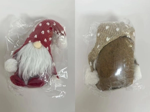 Detail view of two Christmas gnomes with knitted heart hats and long white beards