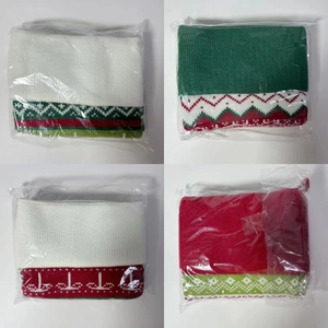 Close-up of four knitted Christmas socks with snowflake patterns in plastic packaging