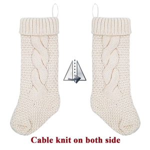 Classic cream white cable knit Christmas stocking with hanging loop on white background