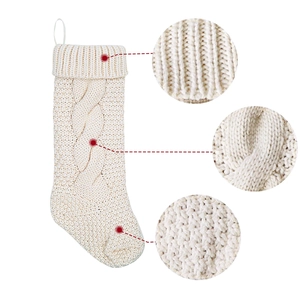Classic cream-white cable knit Christmas stocking with detailed weave textures and loop hanger