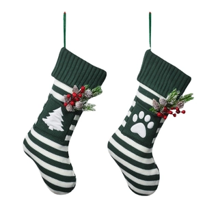 Knitted Christmas socks for cats and dogs with festive pine branch and berry decorations