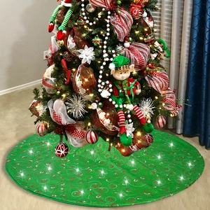 Green Christmas tree skirt featuring festive red and white glitter spiral vortex patterns