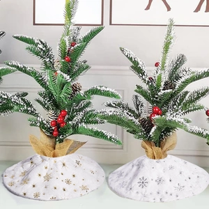 White plush Christmas tree skirts with gold and silver snowflake patterns and soft faux fur