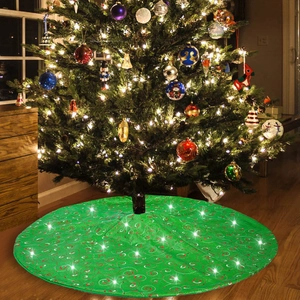 Detailed view of a green Christmas tree skirt with red spirals and white star patterns