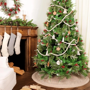 Knitted Christmas tree skirt with wooden ornaments and berries in a cozy home setting