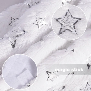 Detailed view of white faux fur tree skirt with silver stars and magic stick fastener