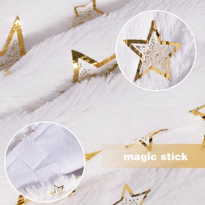 Detail of white faux fur Christmas tree skirt with gold foil stars and magic stick closure
