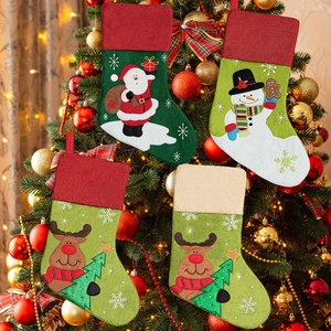 Set of 4 Christmas stockings featuring Santa, snowman and reindeer on a festive tree