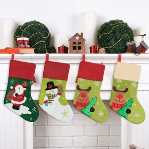 Set of 4 Christmas stockings with Santa and reindeer hanging on a white fireplace