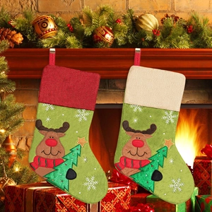 Macro view of Christmas stockings with cartoon reindeer and Christmas tree decor