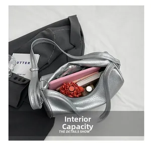Detailed top view of large silver cylinder bag interior showing ample storage space