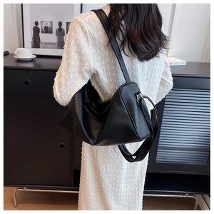Detail of the vintage cracked texture and soft shape on this black crossbody hobo bag