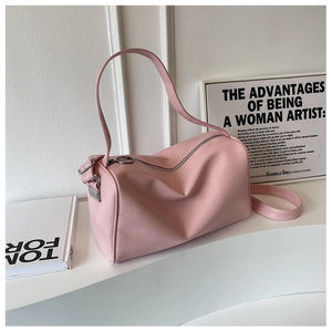 Pink cylinder boston bag with cracked leather texture and large ring zipper detail