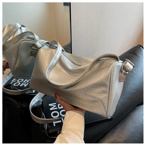 Close-up of silver textured pillow bag with metallic finish and premium hardware details