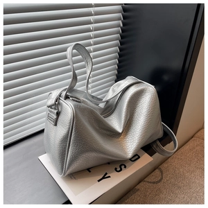 Detail of silver crocodile embossed texture on luxury Boston bag with metallic finish