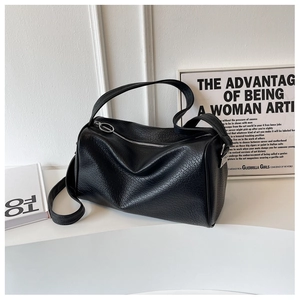 Close-up of black crackle leather texture and silver zipper on Boston handbag