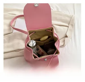 Internal view of a pink PU leather backpack showing large capacity and drawstring closure