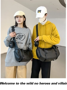 Detail view of black nylon cylinder crossbody bags with small coin pouches shown in pairs