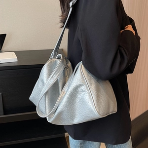Silver large capacity triangle tote bag with crocodile texture worn by a model