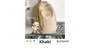 Detail of khaki water-resistant nylon backpack featuring a cute white duck plush charm