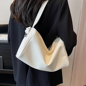 White large capacity crocodile pattern shoulder bag with a wide strap on a model