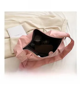 Interior view of large capacity pink nylon crossbody bag with daily essentials storage
