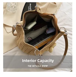 Detail showing the large interior capacity of this woven straw tote bag with daily essentials