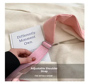 Close-up of pink adjustable shoulder strap with silver metal buckle on oxford bag