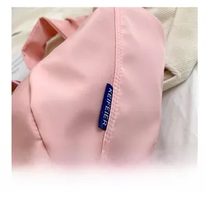Detail shot of blue KEIFEIER label on pink oxford cloth bag with clean stitching work