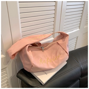 Detail of pink oxford fabric bag with yellow kefeier embroidery on wide strap