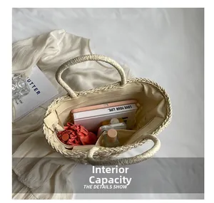 Interior view of straw tote bag showing compartments with umbrella and notebook