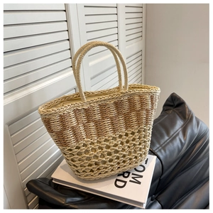 Close-up of handmade woven straw bag featuring gradient beige design and inner lining