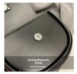 Detail view of the black saddle bag showing the strong magnetic buckle and stitching