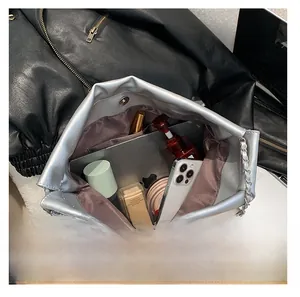 Macro view of silver metallic chain tote bag showing spacious interior and magnetic closure