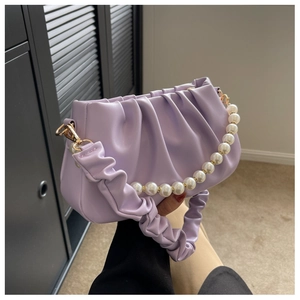 Detail of lavender cloud bag with pleated texture and elegant pearl chain strap