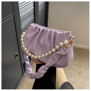 Detail of lavender pleated cloud bag with pearl chain strap and gold hardware accents